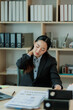 © Wanchai - After hours of focused laptop work, a young Asian businesswoman stretches at her desk to ease tension and support good posture in the office.