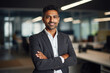 © jogeromonstero - A smiling man in a suit, arms crossed, stands in a modern office