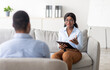 © Prostock-studio - Young black guy speaking to psychologist at office, explaining about his problem to counselor. African American man communicating to psychotherapist. Mental health care concept