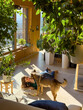 © helivideo - Female student is reading book on the floor of a nature inspired living room when her affectionate dog approaches for cuddle. Doggo distracts her while studying, but she is happy about that and smiles