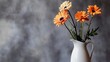 © Nasr - White ceramic vase filled fresh orange flowers placed front of muted gray backdrop studio lit composition minimalism natural beauty combined one elegant shot
