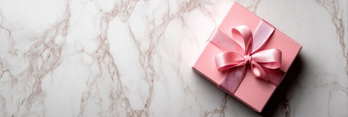 Poster - Elegant Pink Gift Box on a Marble Table Creates a Festive and Inviting Atmosphere Perfect for Celebrations or Special Occasions