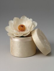 Poster - Elegant Round Box With Silk Wrap and Flower Displayed Open on a Neutral Background