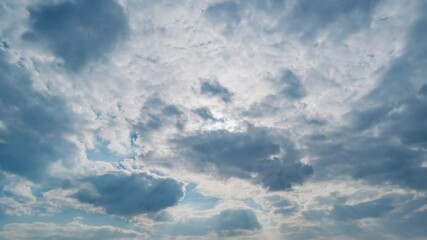 Wall Mural - Beautiful summer day sky with fluffy white clouds time lapse in bright blue atmosphere.