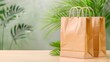 © Aniwat - Eco friendly shopping bag on wooden table with tropical leaves