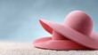 © Gulnaz - Two pink hats are laying on the sand