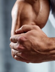 Aufkleber - Close-up of a Muscular Forearm Engaged in Action Against a Soft Blurred Background During a Workout Session in a Gym Setting