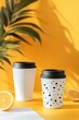 © Namdang - Stylish Coffee Cups on Vibrant Yellow Background with Citrus Slices