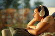 © Antonioguillem - Woman relaxing listening music with headphone at home