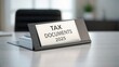 © ANNetz_PK - Tax document holder on a desk, labeled for the year 2025, suggesting organization and preparation.