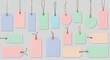 © Citra - Pastel colored price tags hanging on strings, blank paper labels
