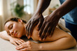 © Peeradontax - A woman enjoys a soothing massage in a peaceful, sunlit room. The atmosphere is serene, promoting wellness and relaxation through therapeutic touch.
