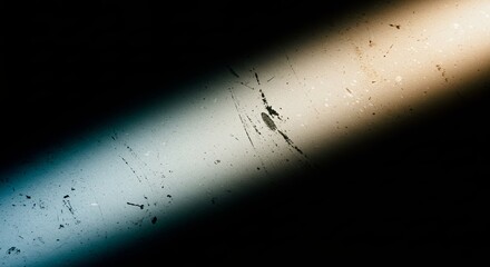 Aufkleber - A blurry line of light is cast on a dark background