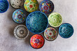 © ADDICTIVE STOCK - Colorful Hand-Painted Ceramic Bowls on Stone Surface