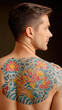 © mamah - A man's back displays a vibrant koi fish and floral tattoo in traditional Japanese style, showcasing detailed waves and blossoms