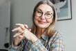© shurkin_son - Closeup portrait of senior therapist smiling at camera giving tips on mental health and advice on reducing stress and getting rid of anxiety having online video session with client