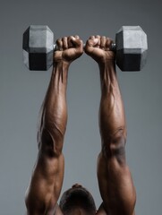 Aufkleber - Strong Arms Lifting a Dumbbell Overhead in a Fitness Studio During a Weightlifting Session Focused on Upper Body Strength Development