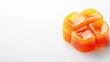 © Light of Art - Close-up view of juicy caramelized fruit candies with glossy surface and vibrant orange color on a pure white background with space for text