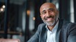 © Adi - Happy middle aged muslim business man ceo entrepreneur, smiling mature professional executive manager, with copy space