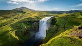 bird s eye perspective of skogafoss waterfall in iceland encircled by verdant hills benea