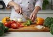© mdshafiq - Chef preparing healthy food with fresh vegetables and sharp knife on cutting board