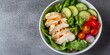 © Saff - Grilled chicken breast salad with cucumbers, cherry tomatoes, and red onion