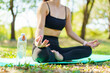 © DG PhotoStock - Asian woman practicing yoga and meditation under a big tree in the park during a peaceful morning.