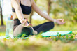 © DG PhotoStock - Asian woman practicing yoga and meditation under a big tree in the park during a peaceful morning.