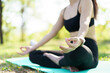 © DG PhotoStock - Asian woman practicing yoga and meditation under a big tree in the park during a peaceful morning.
