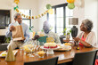 © wavebreak3 - Celebrating birthday, elderly friends exchanging gifts and enjoying cake at home