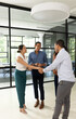 © WavebreakMediaMicro - Business professionals in office shaking hands and smiling during meeting