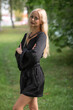 © shymar27 - Portrait of a young beautiful blonde girl in a dark dress in a city dress in the summer.