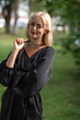 © shymar27 - Portrait of a young beautiful blonde girl in a dark dress in a city dress in the summer.