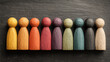 © Chandlerlikes - Wooden figures in different colors arranged on a blackboard, symbolizing diversity in recruitment