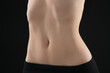 © New Africa - Attractive woman against black background, closeup on belly