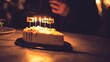 © Amirrosely - Joyful Celebration with Cake and Candles at a Party Gathering