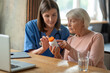 © zinkevych - Nurse explaining senior woman patient medications in medical clinic or in hospice care