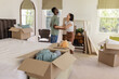 © WavebreakMediaMicro - Couple unpacking boxes in new home, smiling and enjoying fresh start together