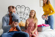 © WavebreakMediaMicro - Family packing suitcase at home, smiling and enjoying vacation preparation together