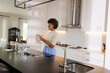 © WavebreakMediaMicro - Woman in modern kitchen drying glassware, preparing for elegant dinner party
