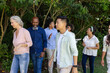 © wavebreak3 - Group of diverse people walking together outdoors, enjoying nature and conversation