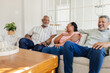 © WavebreakMediaMicro - African American seniors sitting on sofa at home, laughing and enjoying conversation