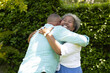 © WavebreakMediaMicro - Senior couple embracing joyfully in garden, sharing warm and happy moment