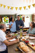 © wavebreak3 - Senior friends enjoying festive meal together, sharing laughter and conversation