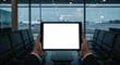 © Ascents - Empty tablet screen held by hands in an airport waiting area.