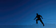 © dinastya - A silhouette of a person is climbing over a barbed wire fence against a gradient sky. Freedom and escape