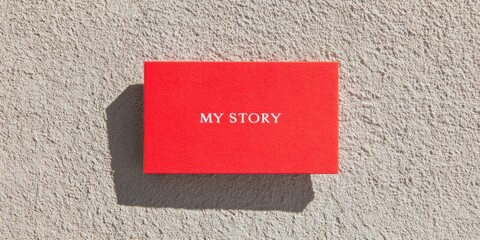 Leinwandbilder - Minimalist Personal Branding Revolution Vibrant Red My Story Business Card on Textured Concrete - Empowering Gen Z Professional Identity Narrative