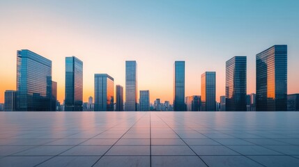 Poster - Empty plaza with tiled floor overlooking modern cityscape with glass skyscrapers at sunset, ideal for corporate branding visuals