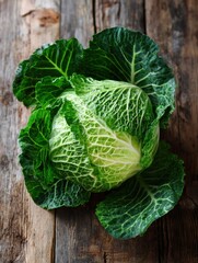 Poster - Fresh Cabbage Head With Vibrant Outer Leaves Resting on a Rustic Wooden Table in a Sunlit Kitchen