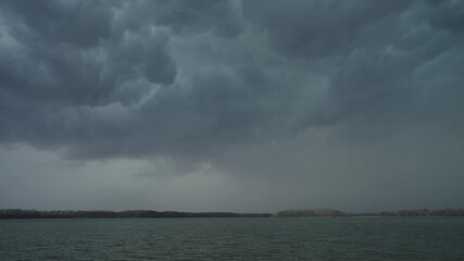 Wall Mural - dark cloudy sky with thunder and lightning over seascape. wide shot